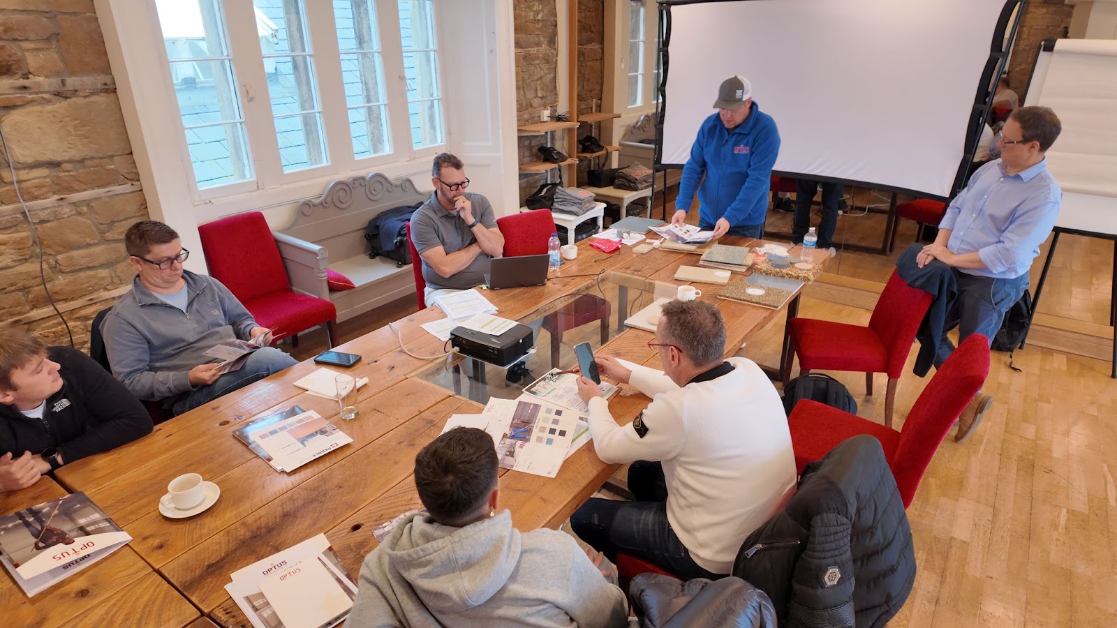 men sitting at a table at a coatings training program