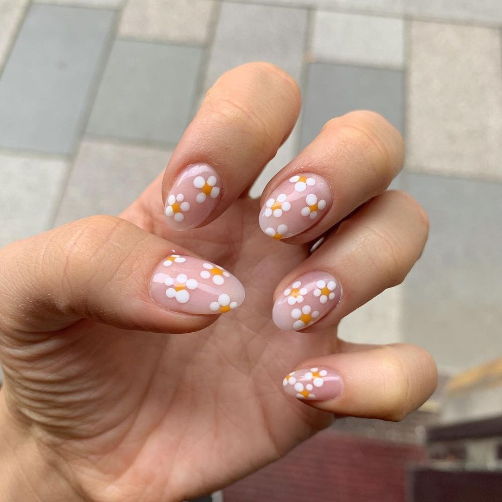 Close up of flowered short nail design with