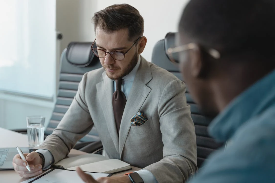 An interviewer taking notes in an interview