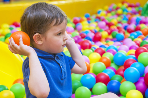 child playing with balls during speech therapy