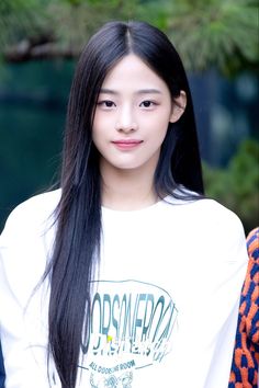 This contains an image of NewJean Minji on a white shirt looking amazing