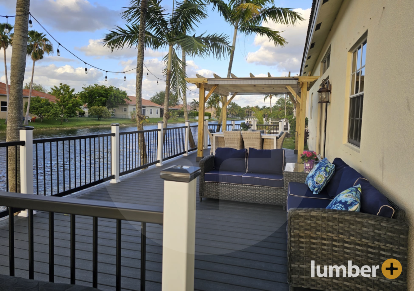 A dark composite wood deck overlooking a peaceful water canal.