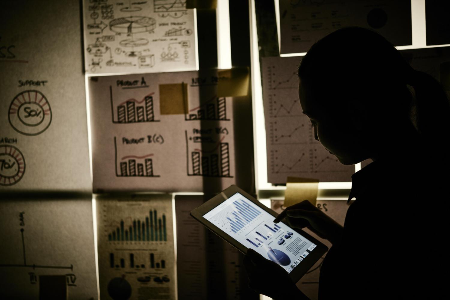 Woman looking at statistics in the dark