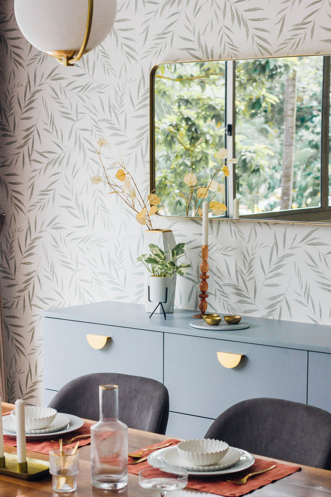 Botanical Foliage Wallpaper in dining room with mirror and pendant light.
