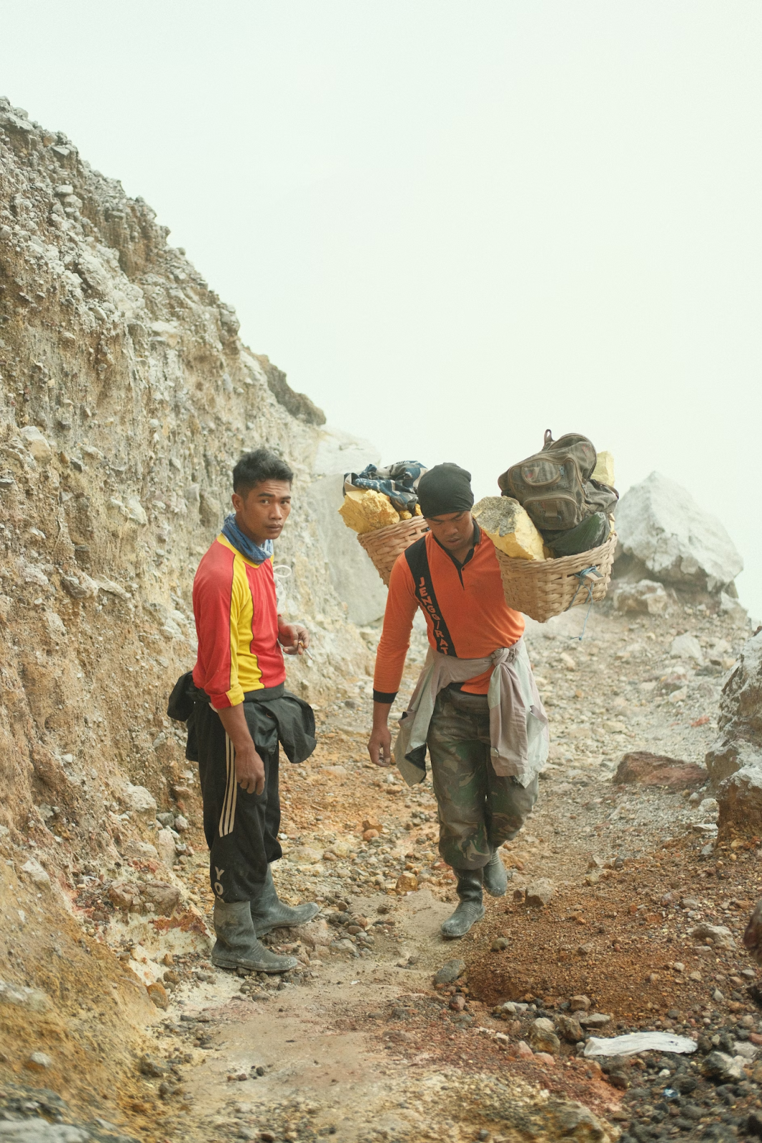 sulfur miners carrying sulfur stone