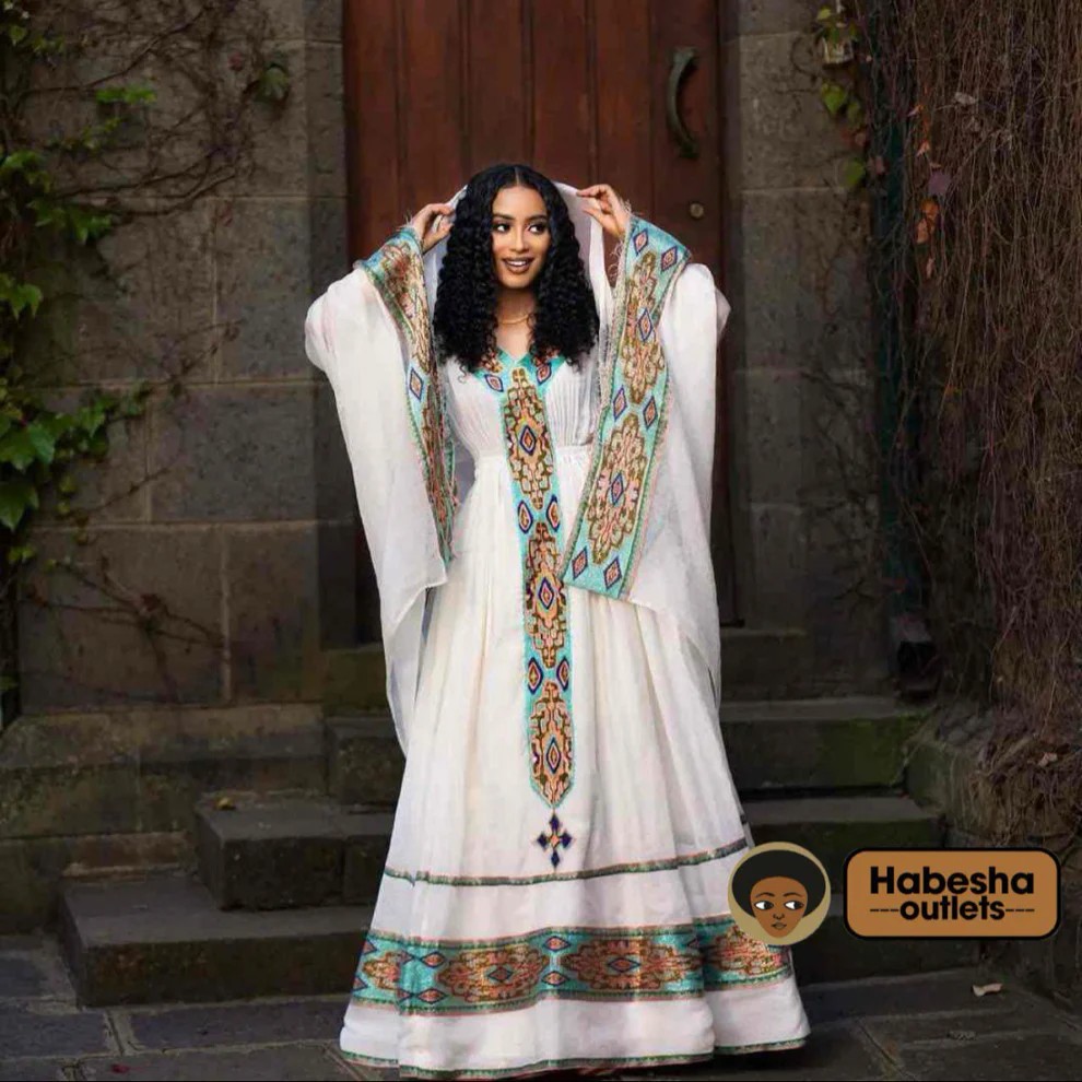 Woman wearing a traditional Habesha dress with an embroidered netela shawl, highlighting cultural elegance for diaspora occasions