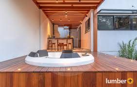  Hot tub surrounded by dark wood deck with subtle deck lighting.