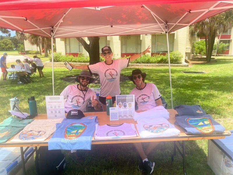 Camp counselors at check in table for signature sports camp