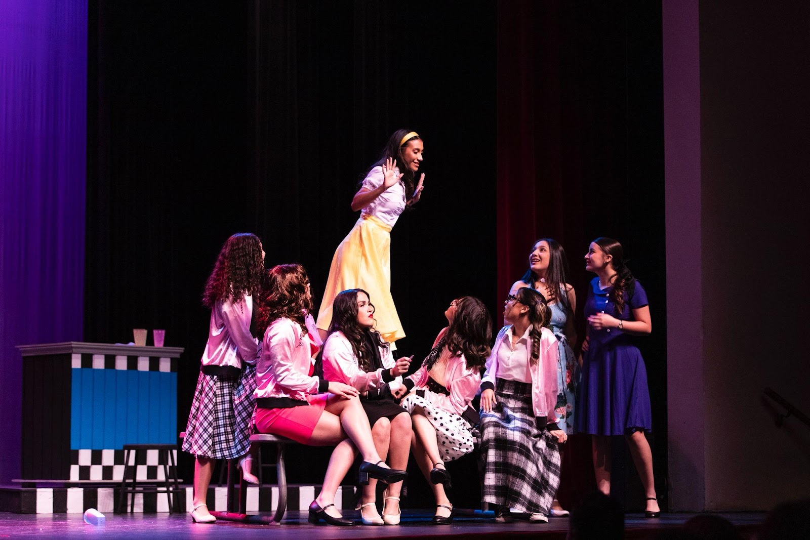 A group of women on a stage

Description automatically generated