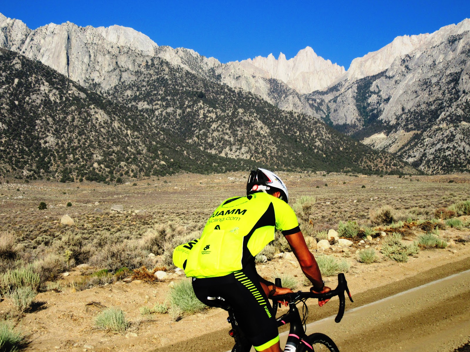 Climbing by bike California top bike climbs - PJAMM Cyclists on bike with Mt. Whitney in background