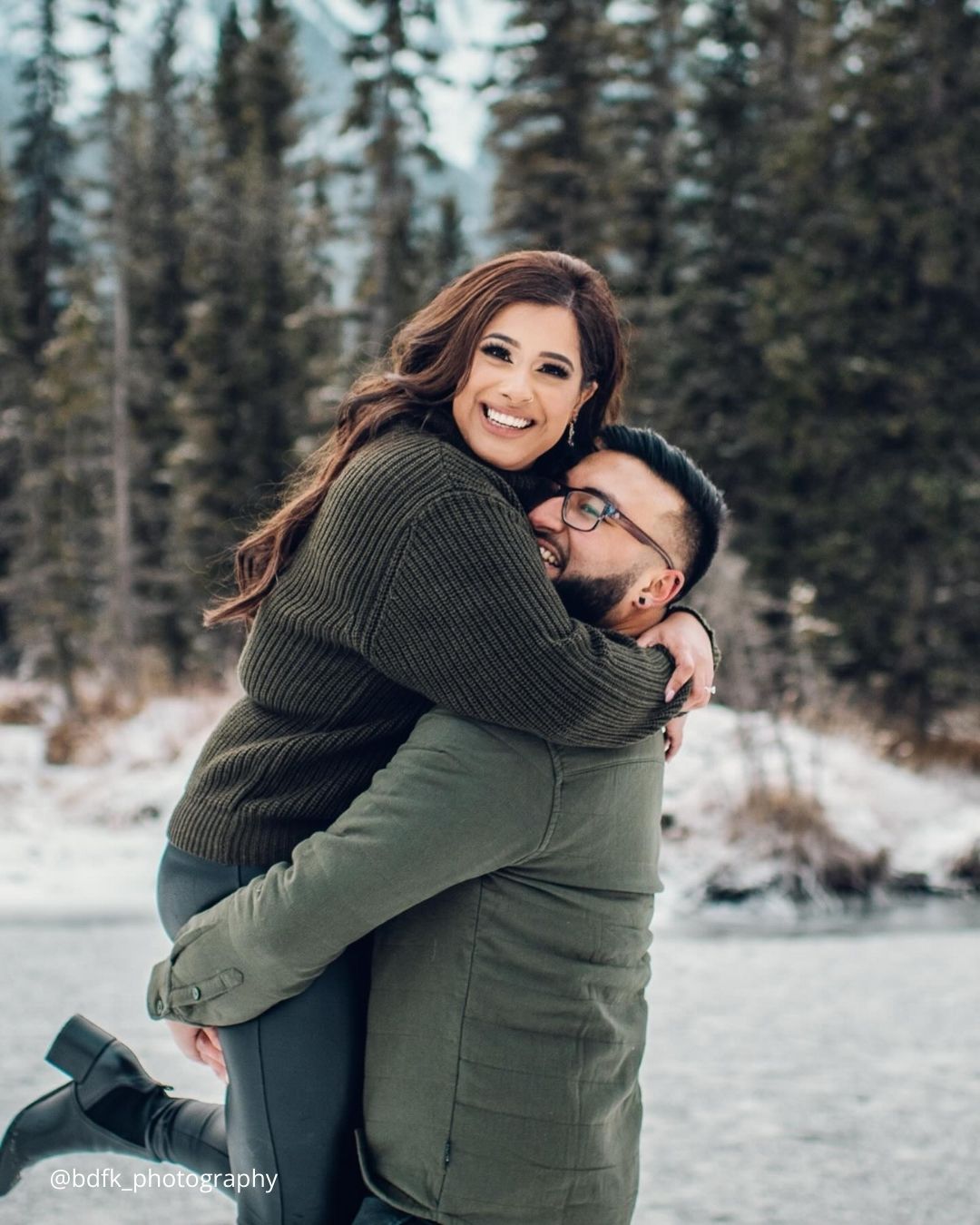 winter engagement photos boy is holding his girl