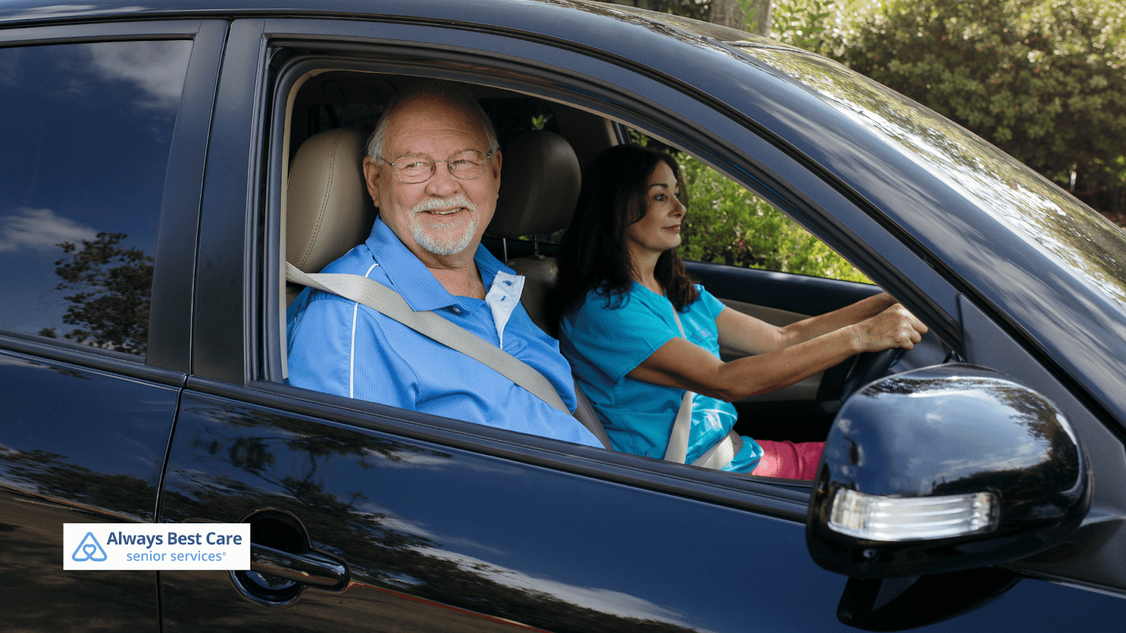 This image depicts a caregiver driving a senior man around