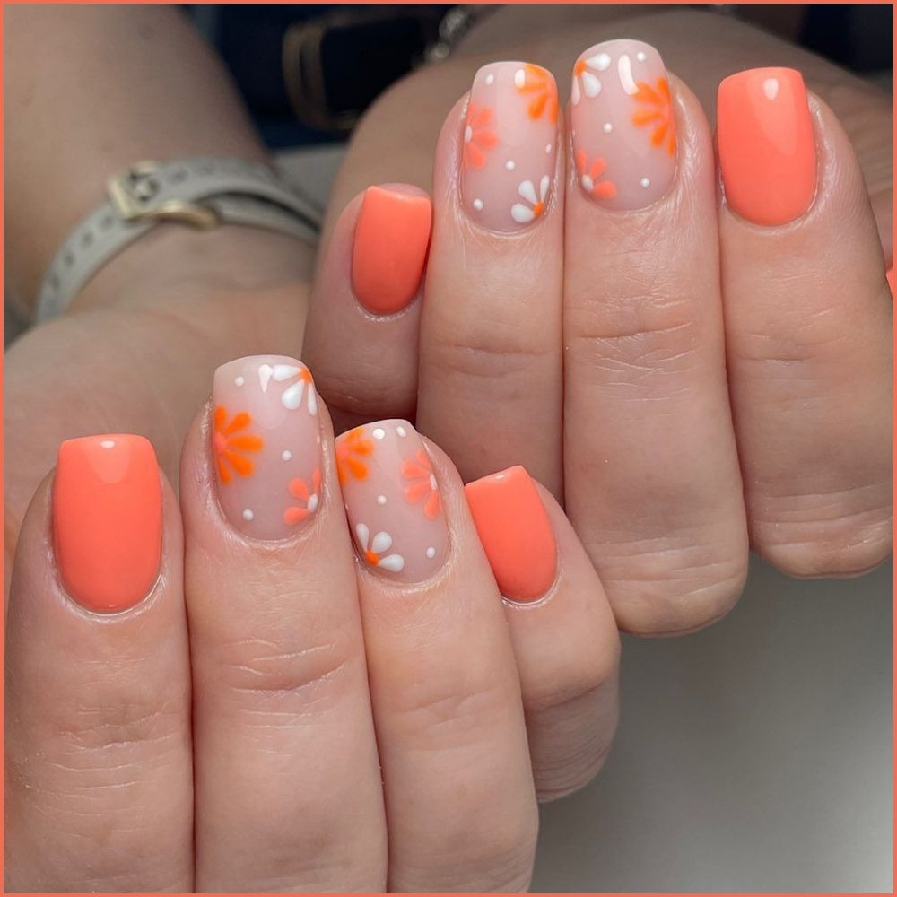 Close up of flowered short nail design with peachy florals