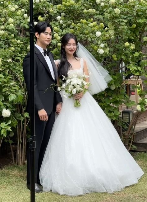 This contains a picture of Kim Hyun Sung and Monika on there wedding day