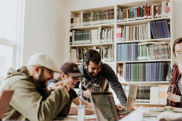 A group of people looking at a computer.