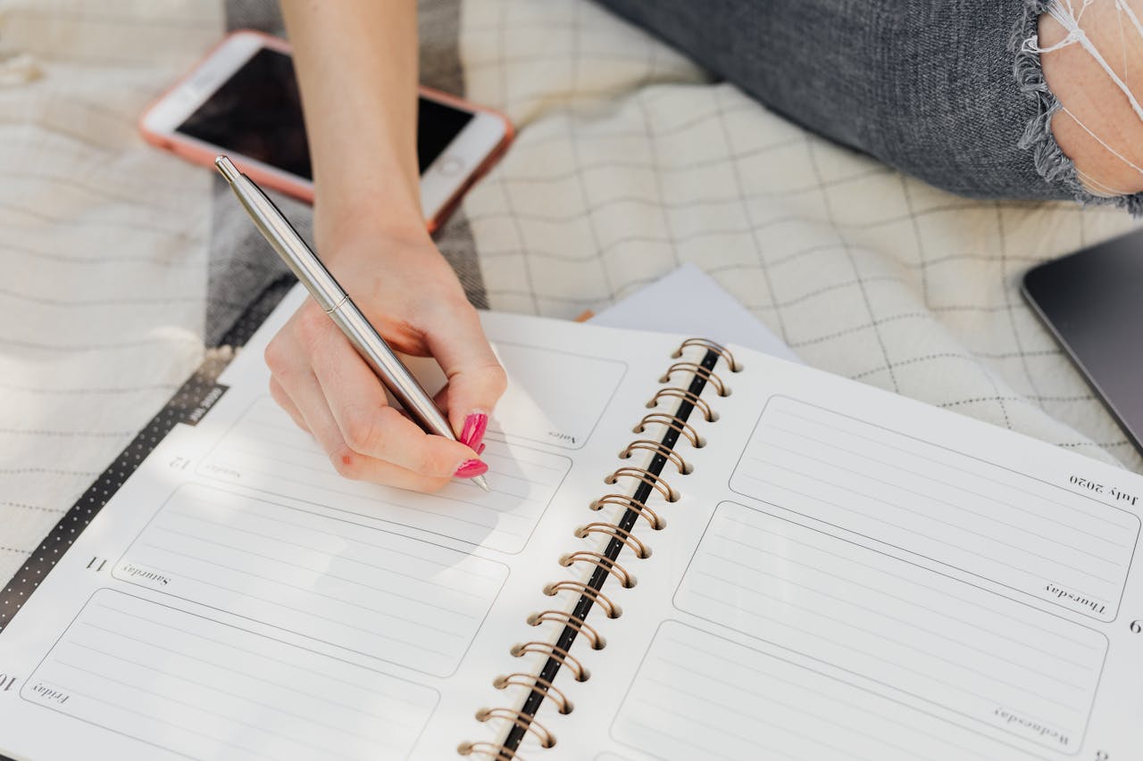 A woman writing on a notebook