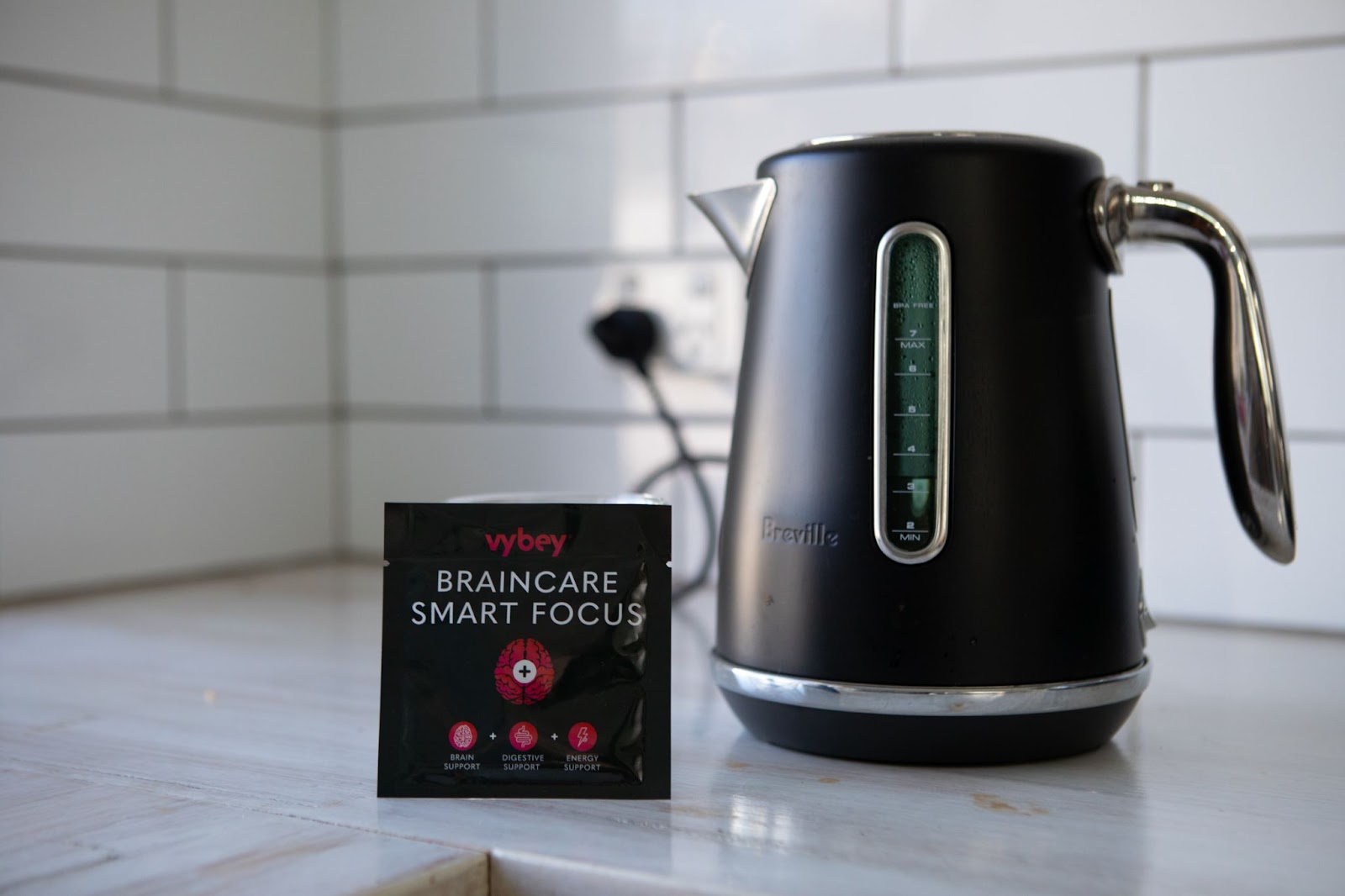 vybey Braincare Smart Focus packaging placed next to a kettle, showcasing the ultimate coffee alternative for sustained energy and enhanced mental clarity.