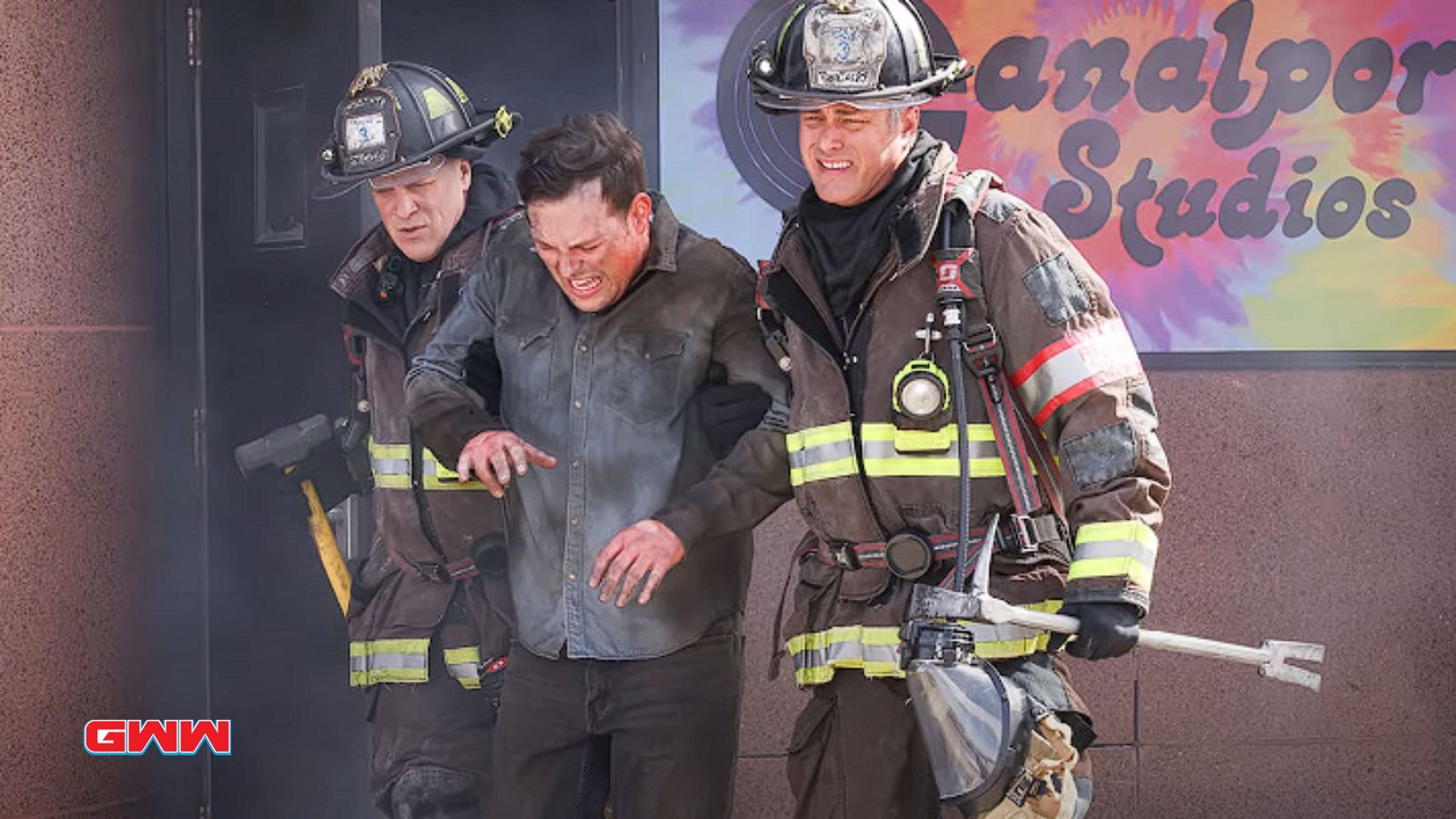 Joe Miñoso and David Eigenberg rescuing a man on Chicago Fire Season 13.