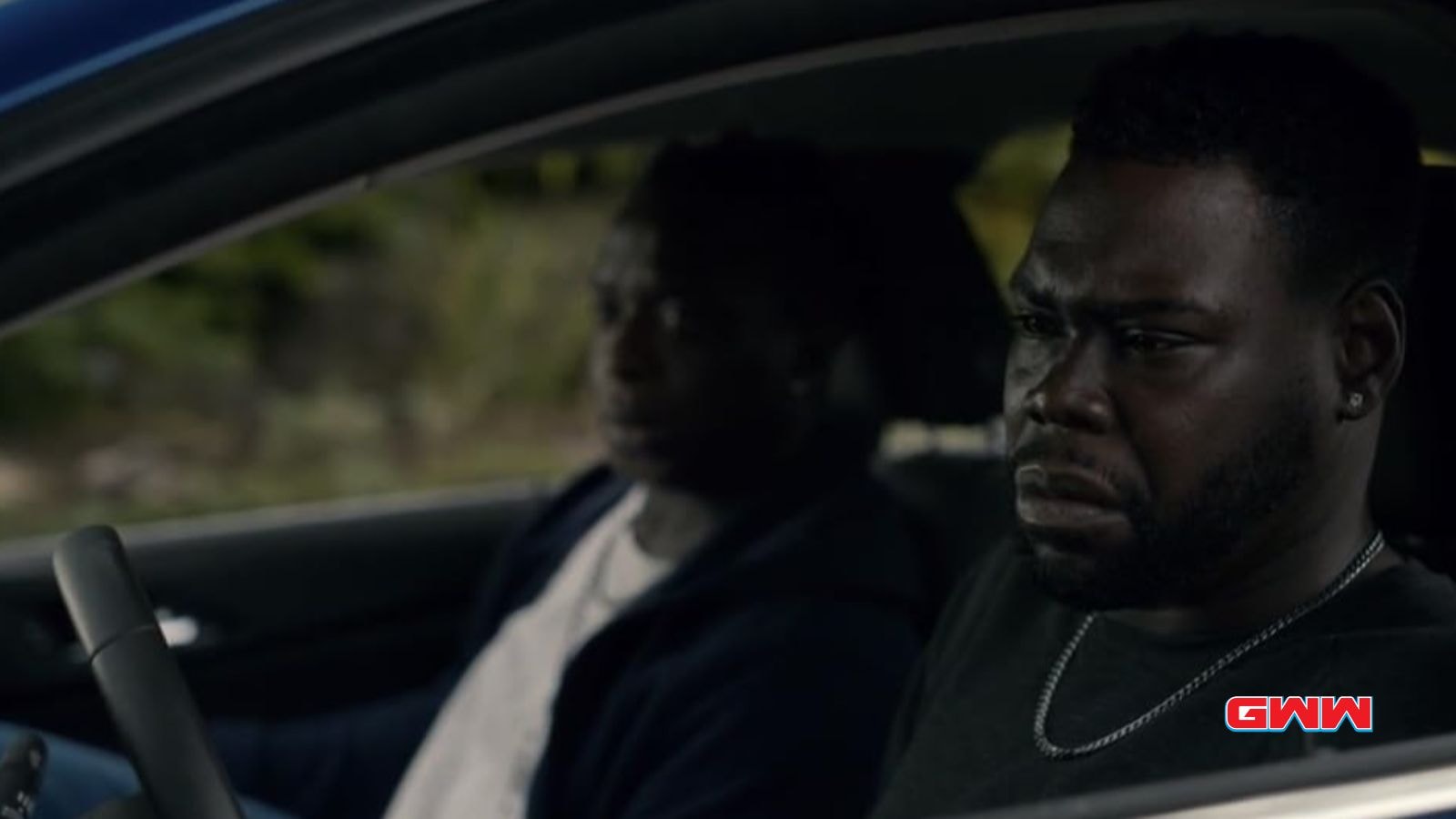 Lamar sitting in a car, one looking upset and worried.