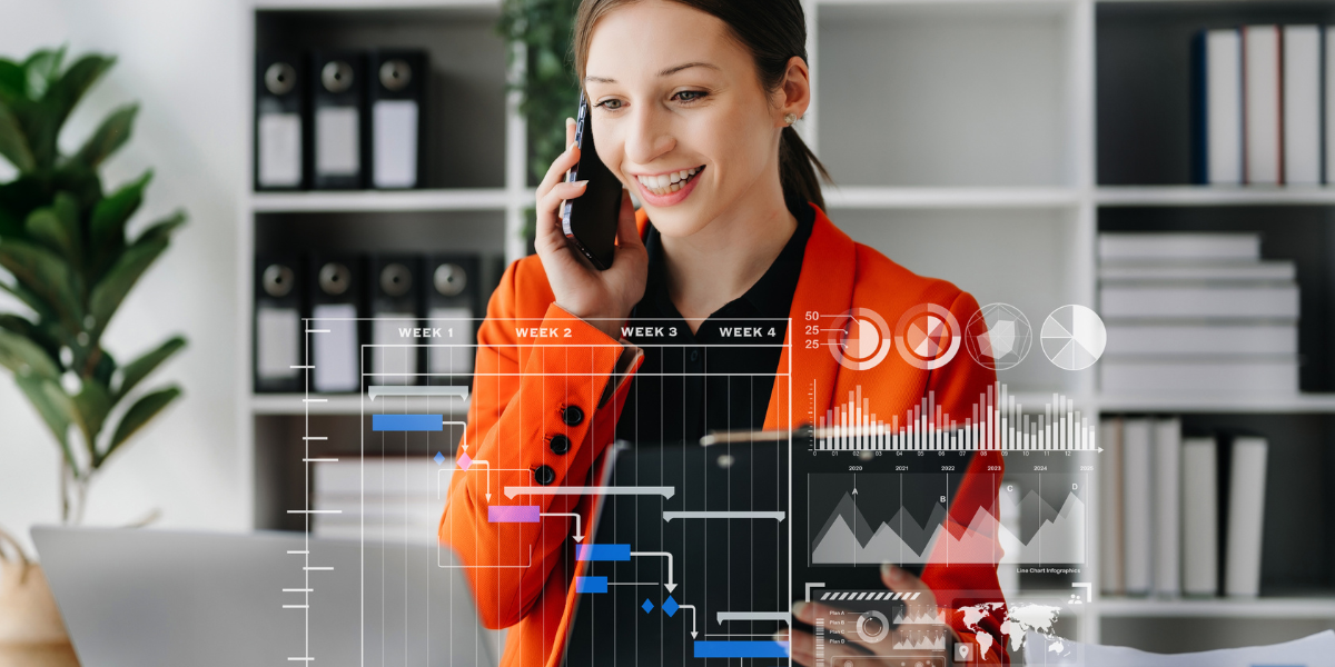 Businesswoman in an orange blazer discussing analytics, highlighting the performance insights provided by the best Airbnb management software.