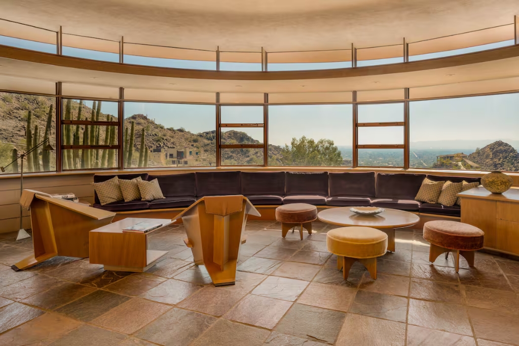tiled floors and rounded windows with views of the desert sky and cactuses in an airbnb in pheonix arizona