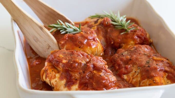 Easy Delicious Mozzarella Stuffed Chicken Breasts in a serving dish.