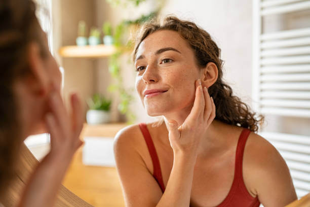 A smiling woman with clear, healthy skin after managing rosacea symptoms successfully.