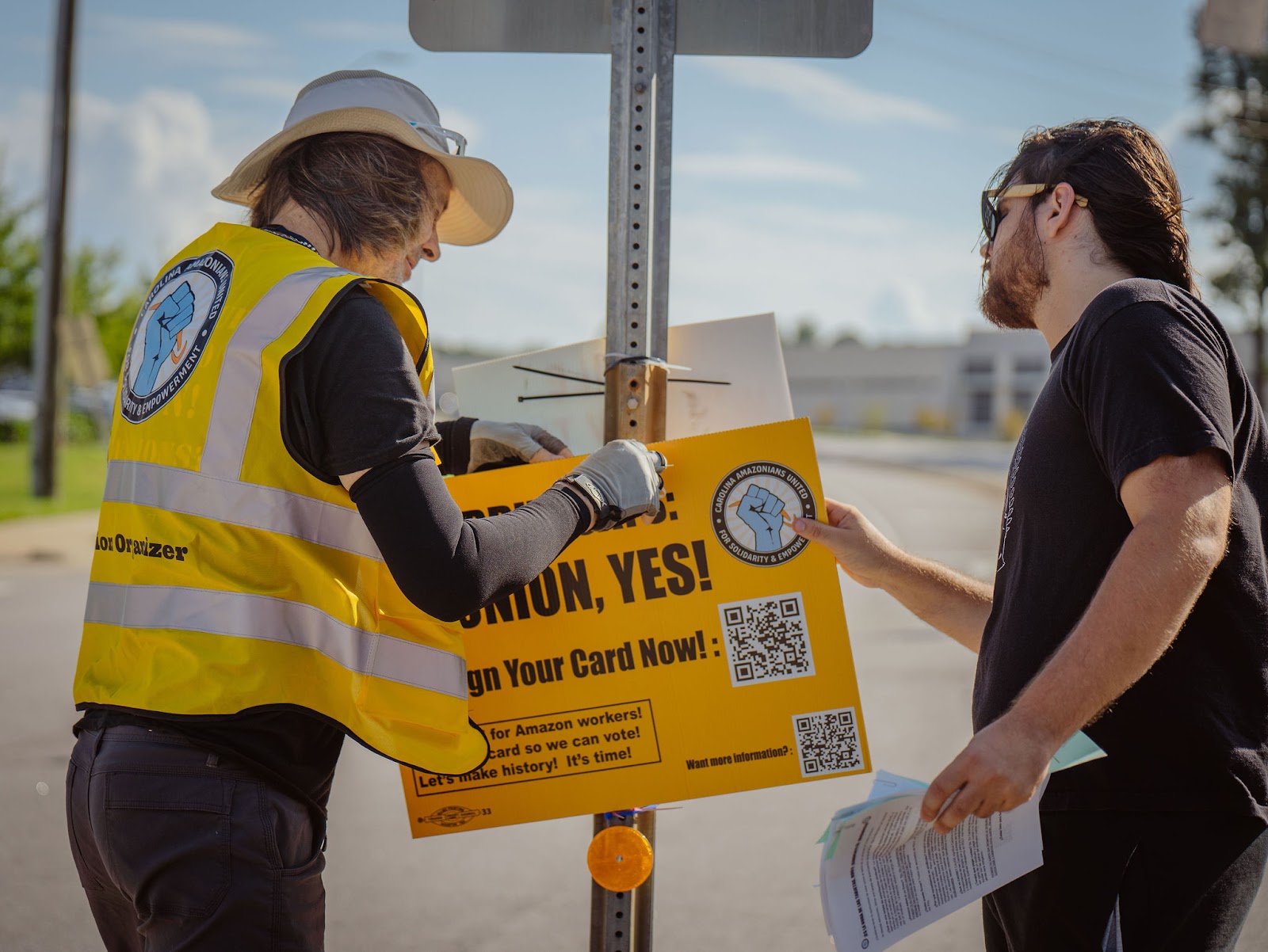 Amazon workers hang a pro-union sign 