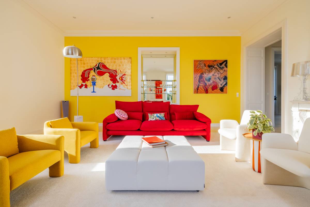 A colorful sitting area with sunlight at Chateau de Lasfonds