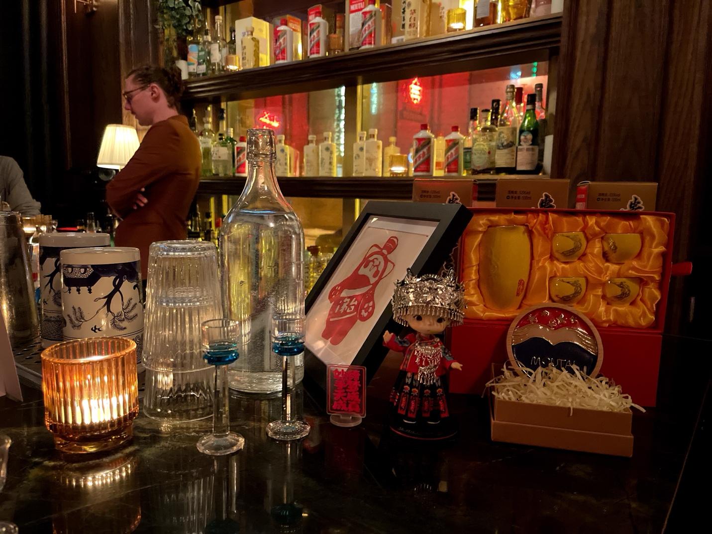 A bar with bottles and glasses

AI-generated content may be incorrect.