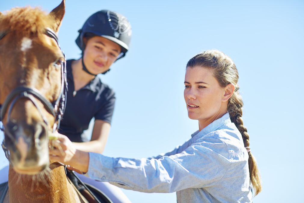 Workouts for Horseback Riders - ladies standing beside a horse