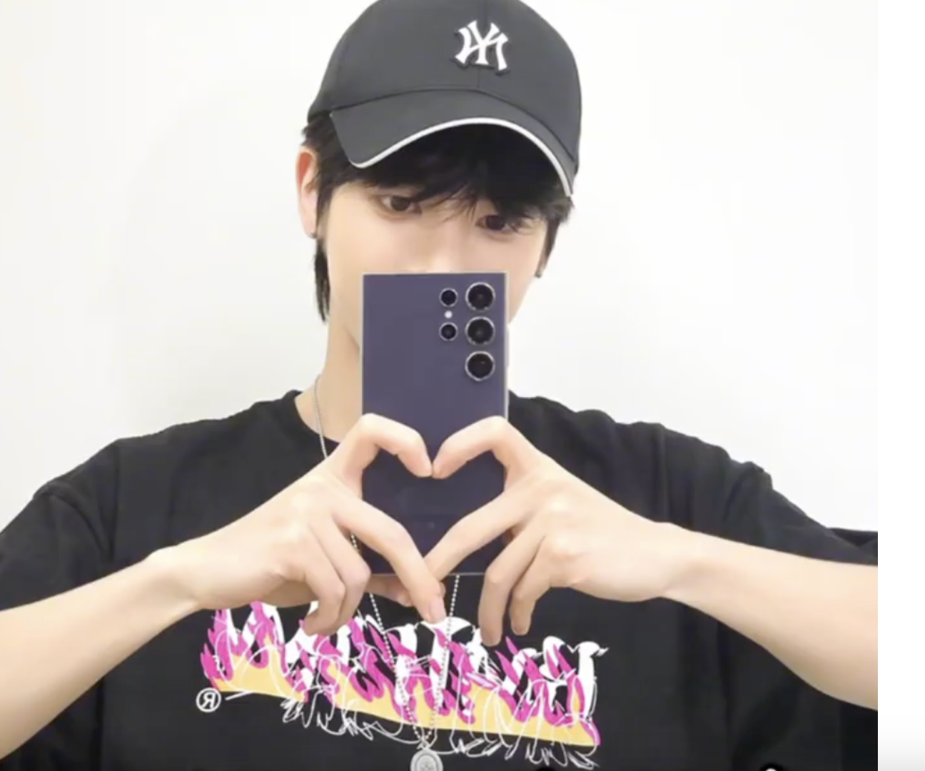 A picture of MOAs holding  a phone with his two hands 