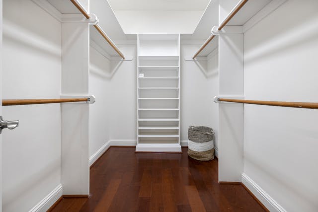 Empty closet with basket in corner of room