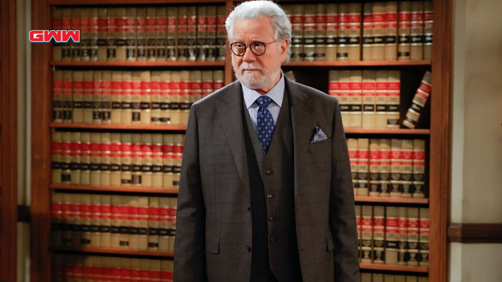 Dan Fielding in glasses stands confidently in a law office.