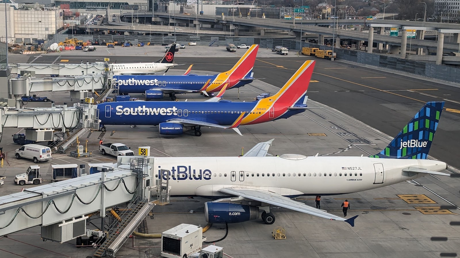 Air Canada, JetBlue, and Southwest Airlines aircraft at New York LaGuardia Airport LGA shutterstock_2473321107