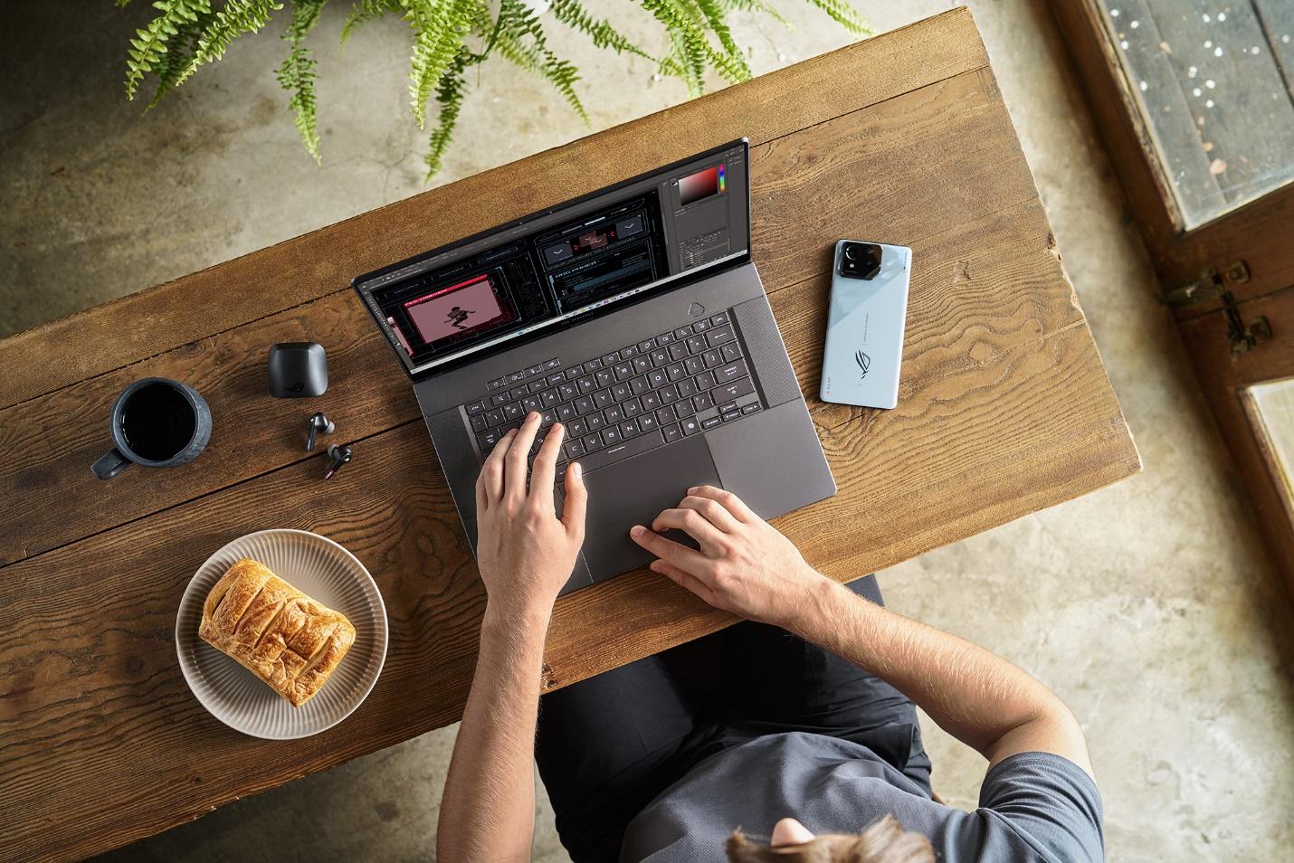 A person sitting at a table using a computer

Description automatically generated