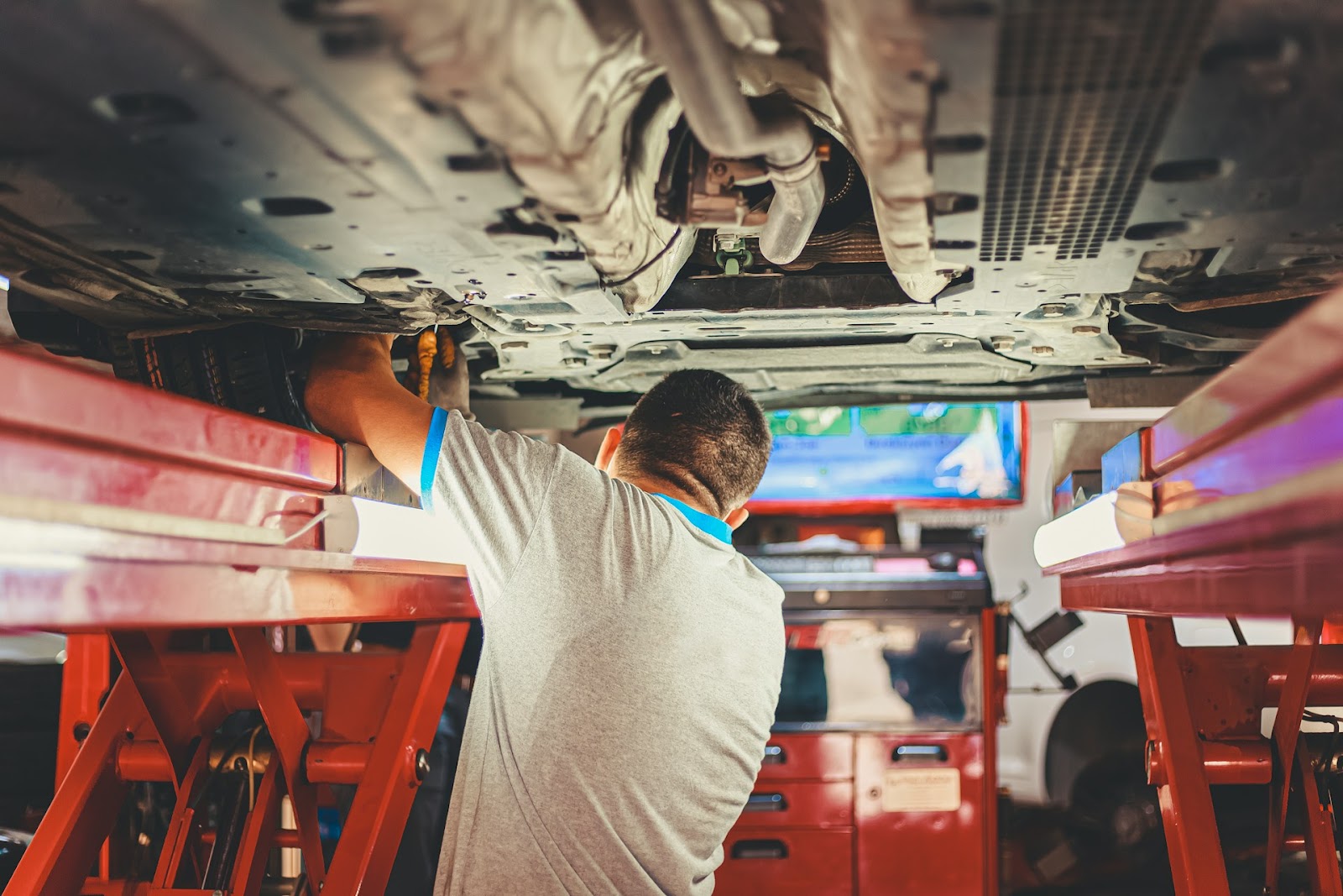 mechanic checks the condition of the vehicle