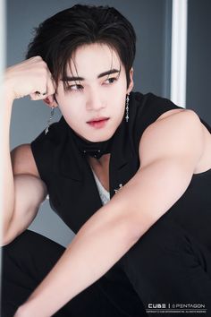 This contains an image of Yanan putting on black suit with white inner 