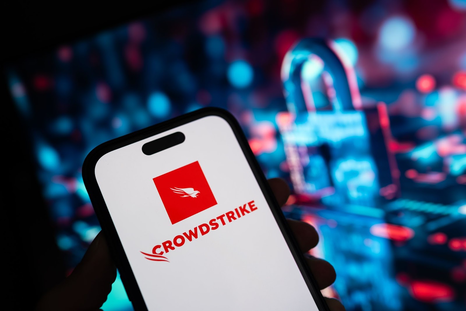 CrowdStrike logo on a smartphone, tech background.