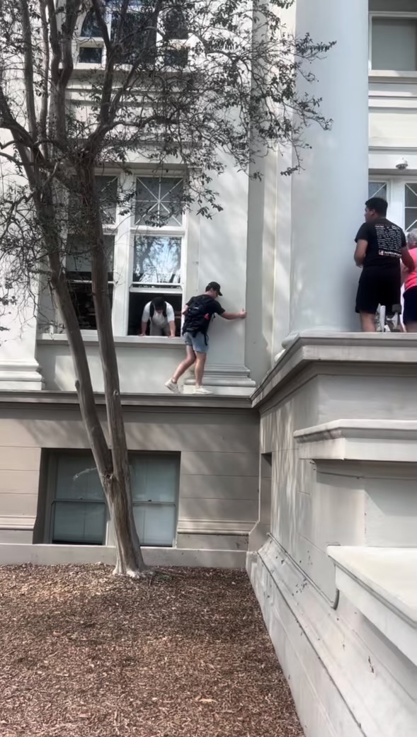 Students exiting Carnegie through windows