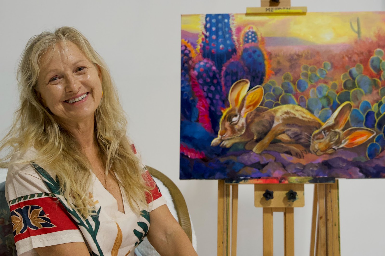 Woman sitting in front of rabit painitng Mary Ambrose, Mastery Program graduate
