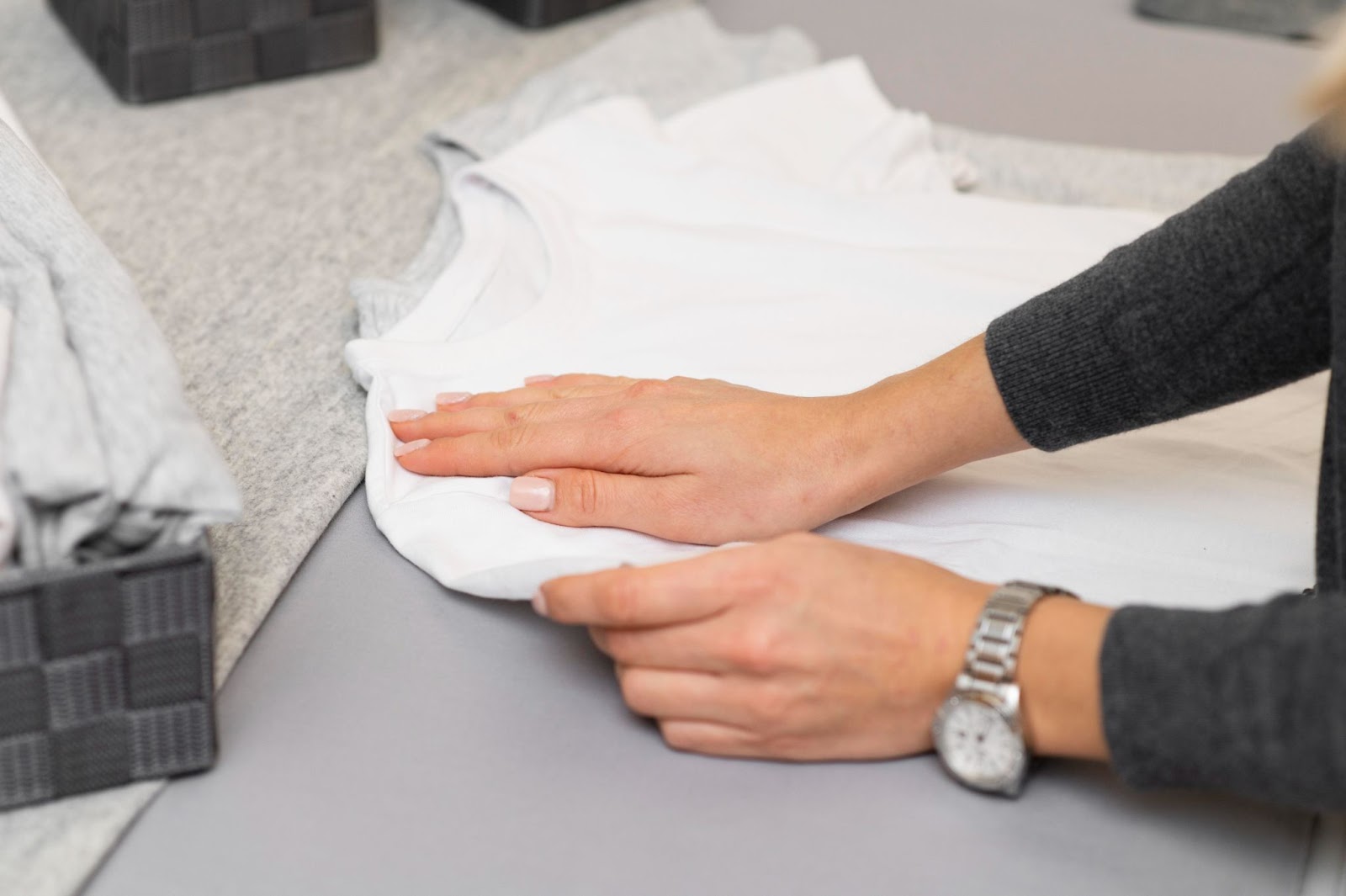 Woman preparing a white T-shirt for custom printing.