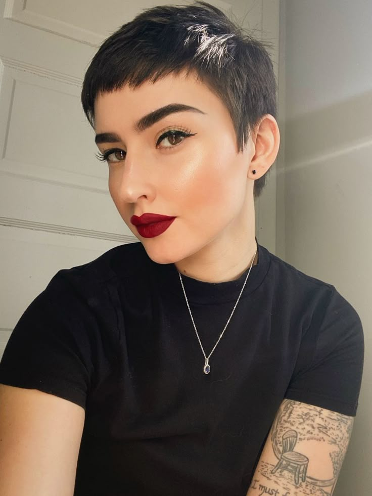 a lady wearing a bold rd lisptick and showing off her short hairstyle