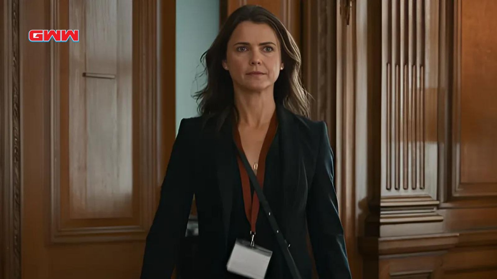 Keri Russell walking confidently in office setting