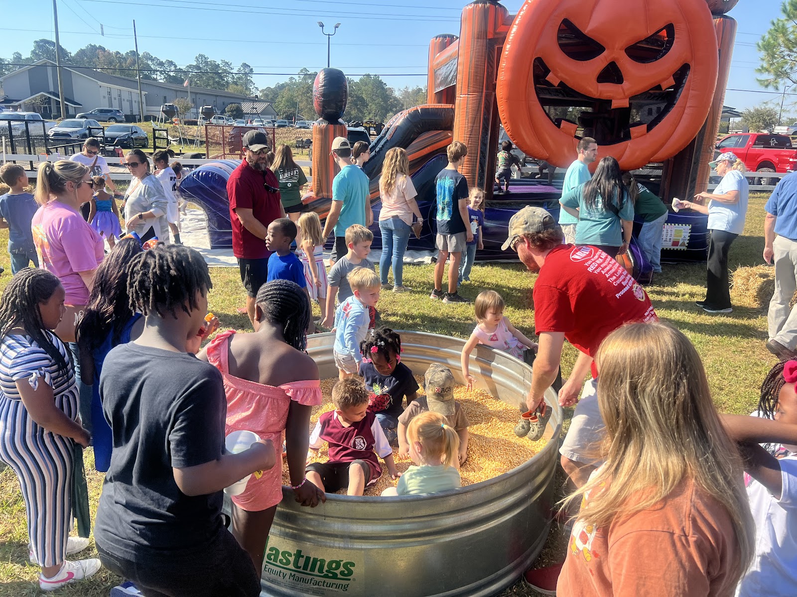 kids playing in tub of corn