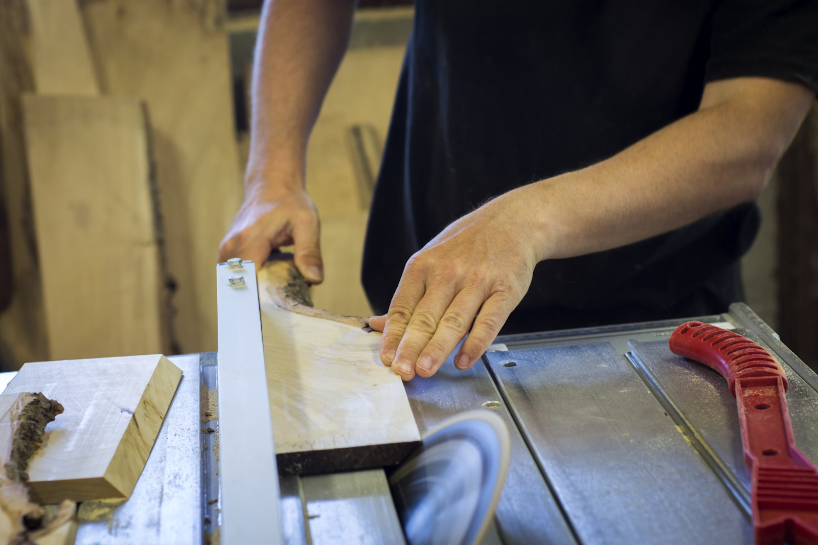 This image depicts a table saw cutting a piece of wood.