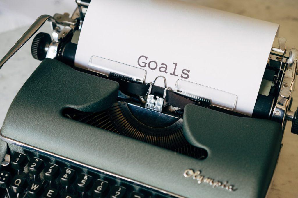 Typing out your goals on a typewritter.