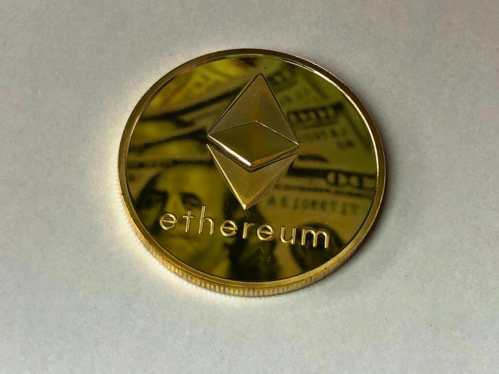 An Image of Ethereum Coin On White Surface