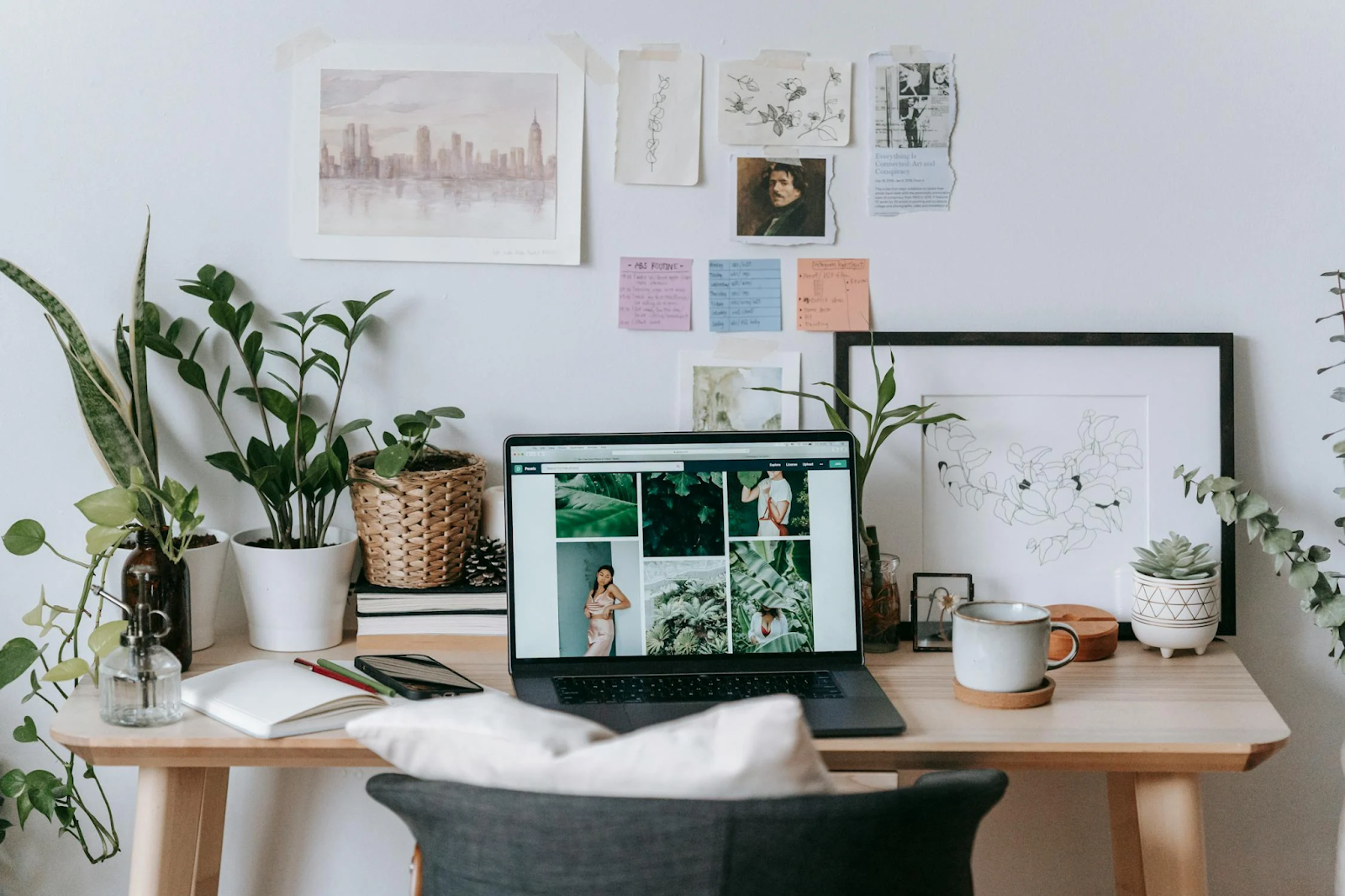 Desk and laptop with post-it notes and illustrations