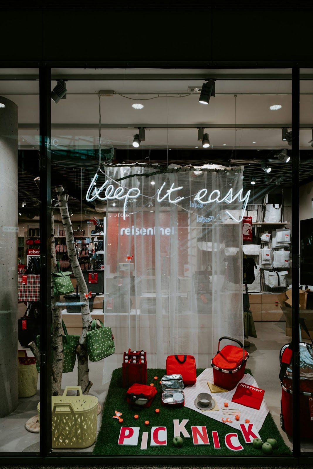 A store window featuring a bright sign that reads "Pick it Up," inviting customers to come inside and shop.